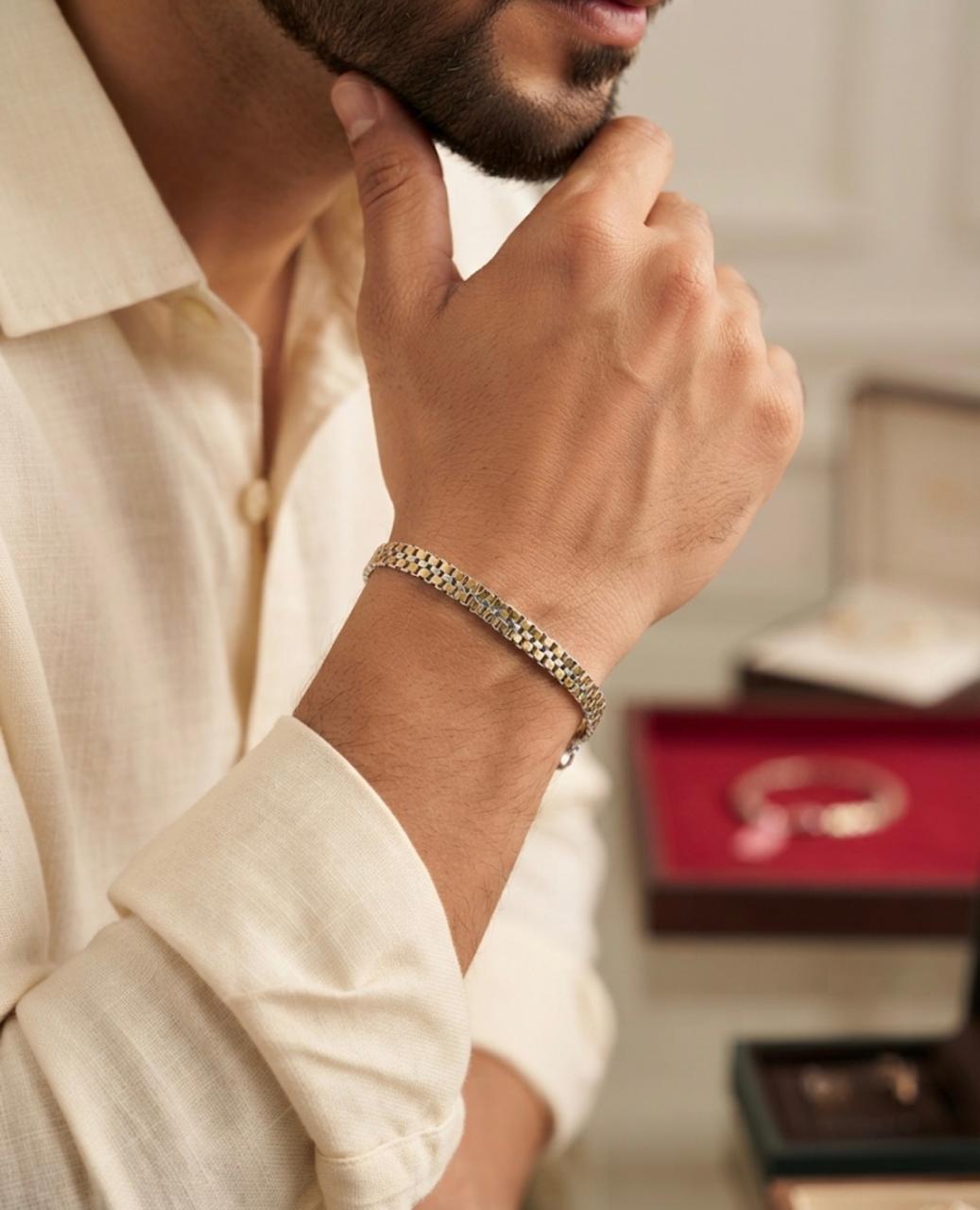Close-up of a 925 sterling silver twin row box weave bracelet worn on a man's wrist with an off-white shirt in an indoor setting.