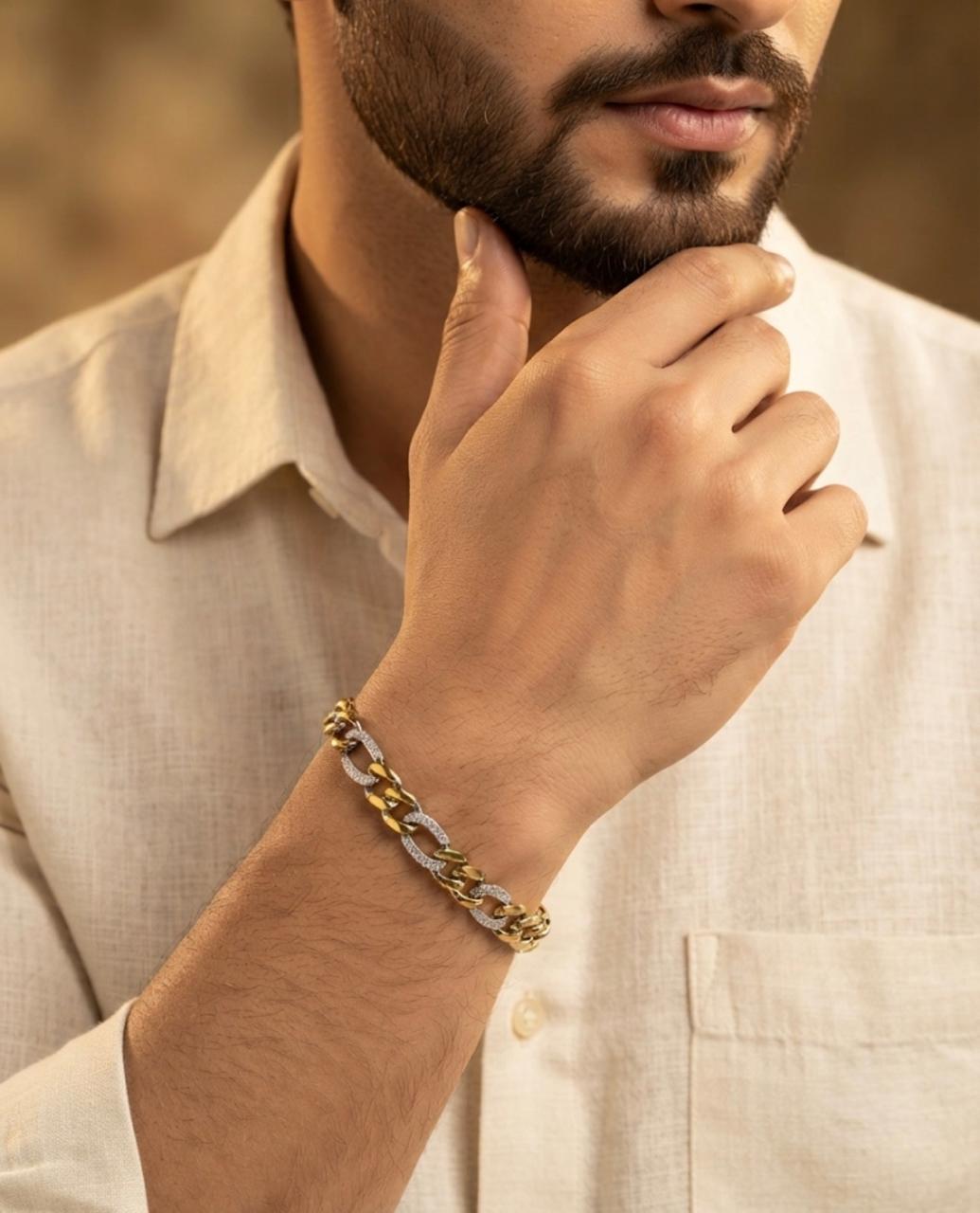 Close-up of a man wearing a 65% purity silver bracelet with twisted dual-tone oval links and textured silver accents, paired with an off-white shirt.