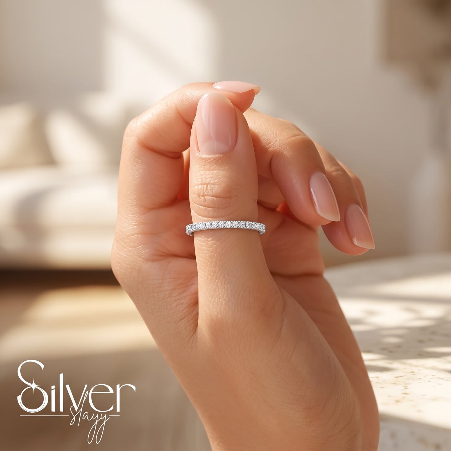 925 sterling silver slim micro pavé band ring worn on a woman's finger in natural daylight.