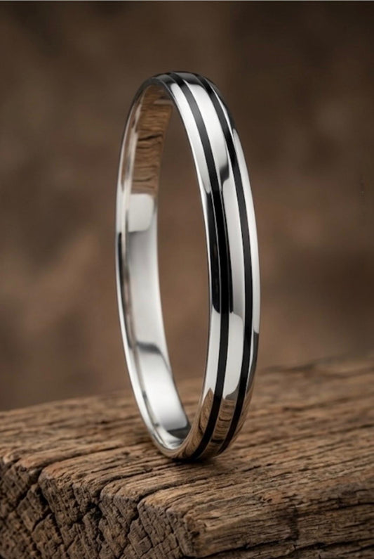 925 silver men's kada showing dual dark stripe inlays and smooth polished surface on a wooden display.