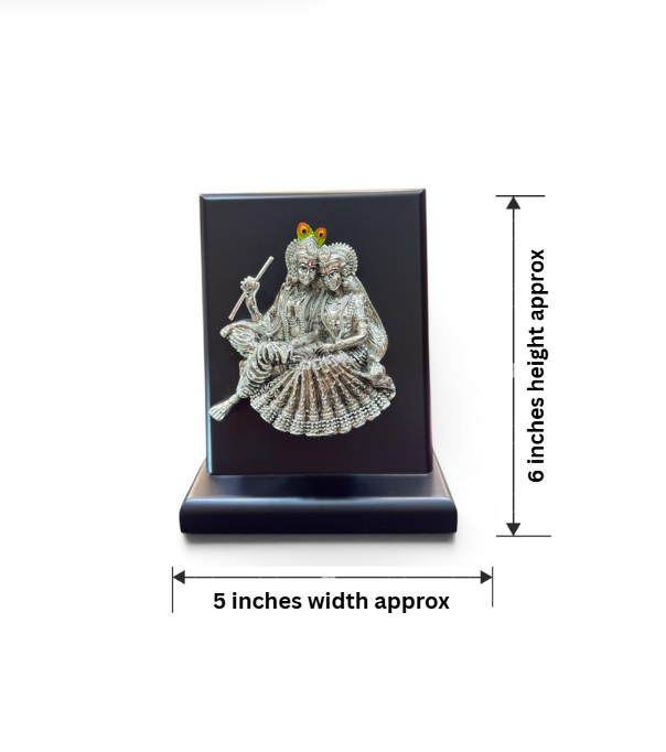 999 pure silver plated Radha Krishna gifting idol displayed on a black base, featuring Krishna with a flute, detailed figures and peacock-feather accents, approximately 6 inches high and 5 inches wide.
