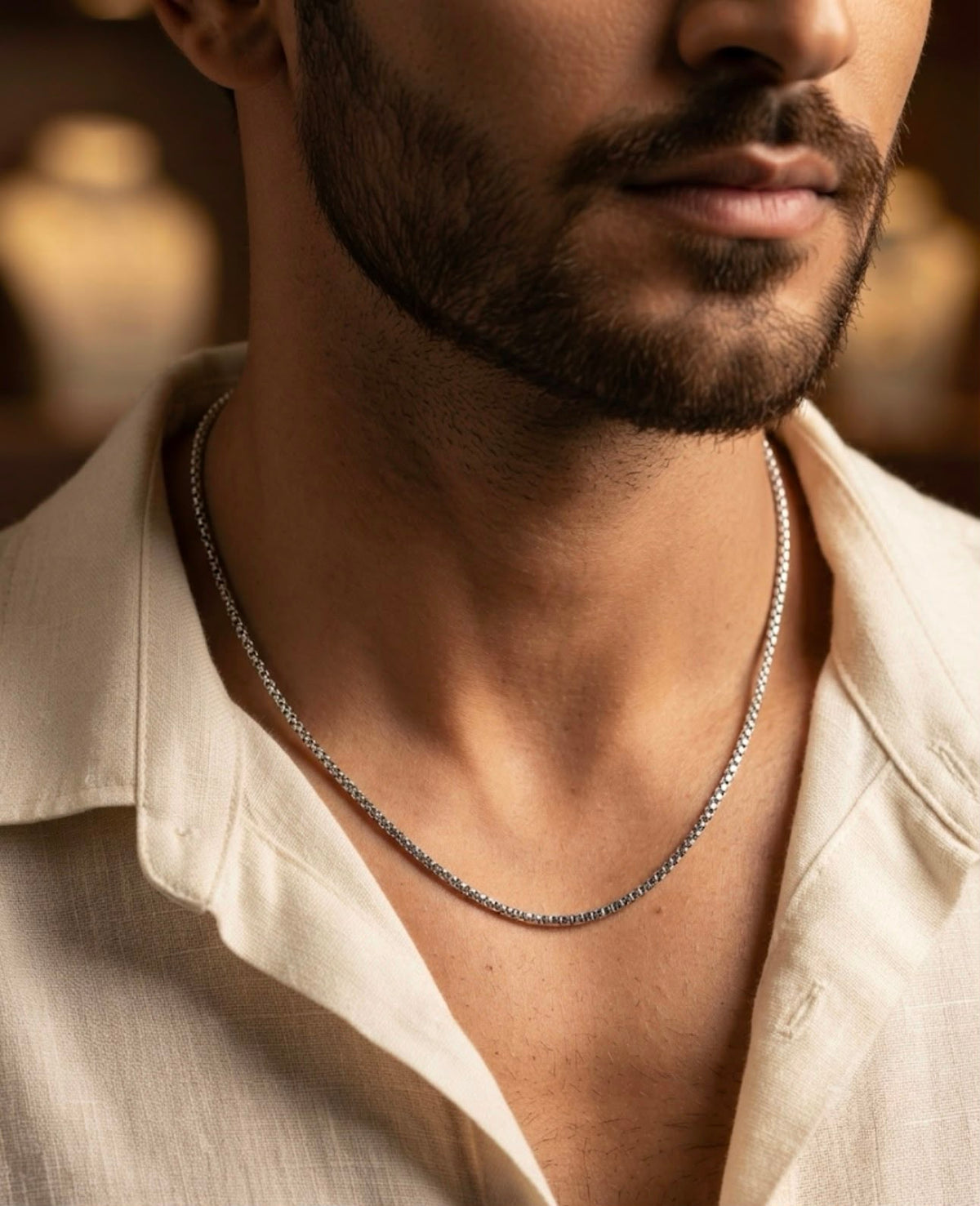 Man wearing a 925 sterling silver chain with a fine micro-beaded link pattern around the neckline.