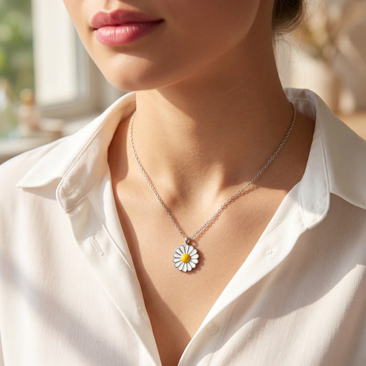 Front view of a 925 silver chain necklace featuring a white and yellow daisy flower pendant, worn on a woman's neckline over a white shirt.