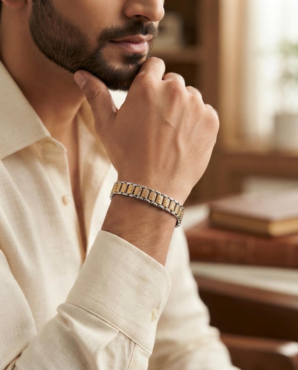 Close-up of a 65% purity silver bracelet with twin rail rope-style links worn on a man's wrist with an off-white shirt.