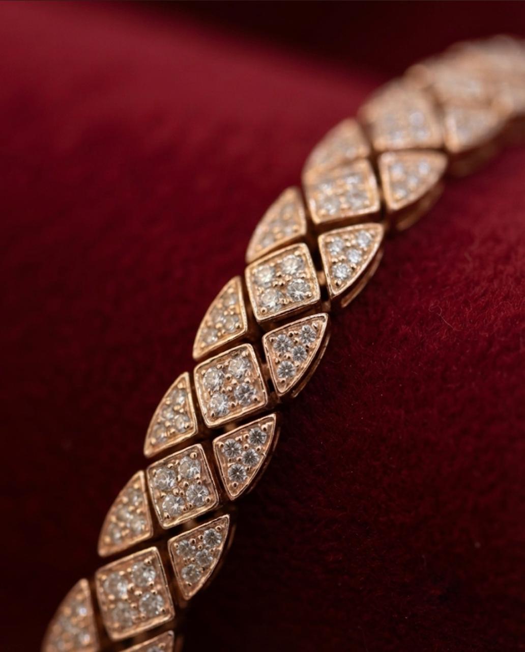 Macro close-up on velvet of a 925 sterling silver men's bracelet with rose gold tone pave geometric links.