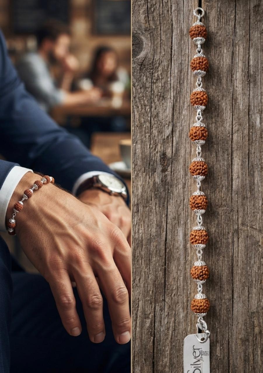 Flat lay view of a 925 sterling silver bracelet made of natural Rudraksha beads with silver end caps on a rustic wood background.