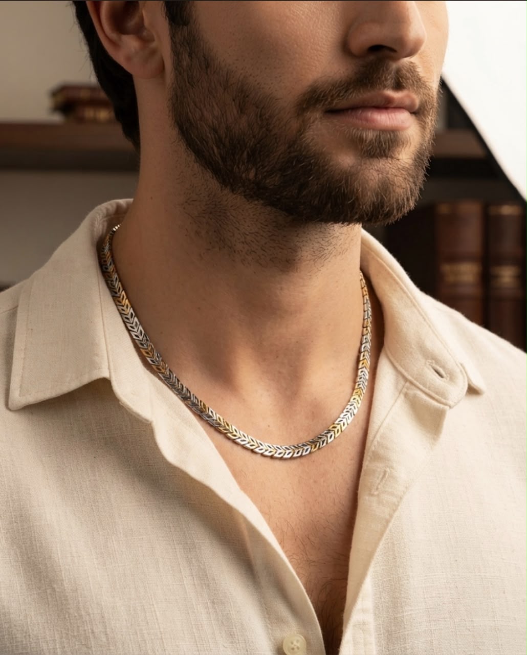 Side profile of a man wearing a 925 sterling silver dual-tone chevron link chain with an open collar shirt.