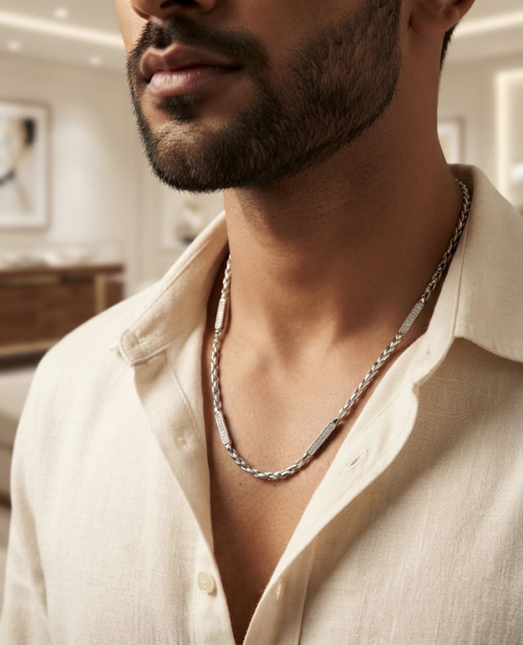 Close-up of a man wearing a 20-inch 925 sterling silver twisted rope chain with pave stone bars over an open cream shirt