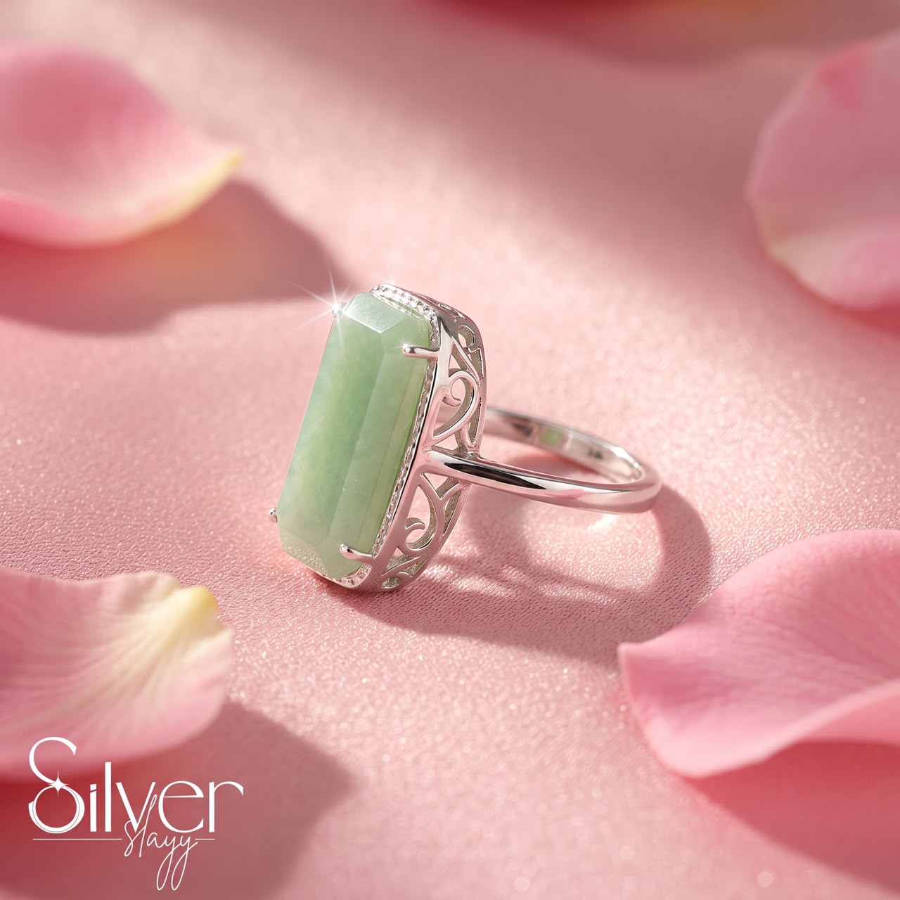 Close-up of a 925 sterling silver ring with a green stone and slim silver band.