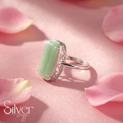 Close-up of a 925 sterling silver ring with a green stone and slim silver band.