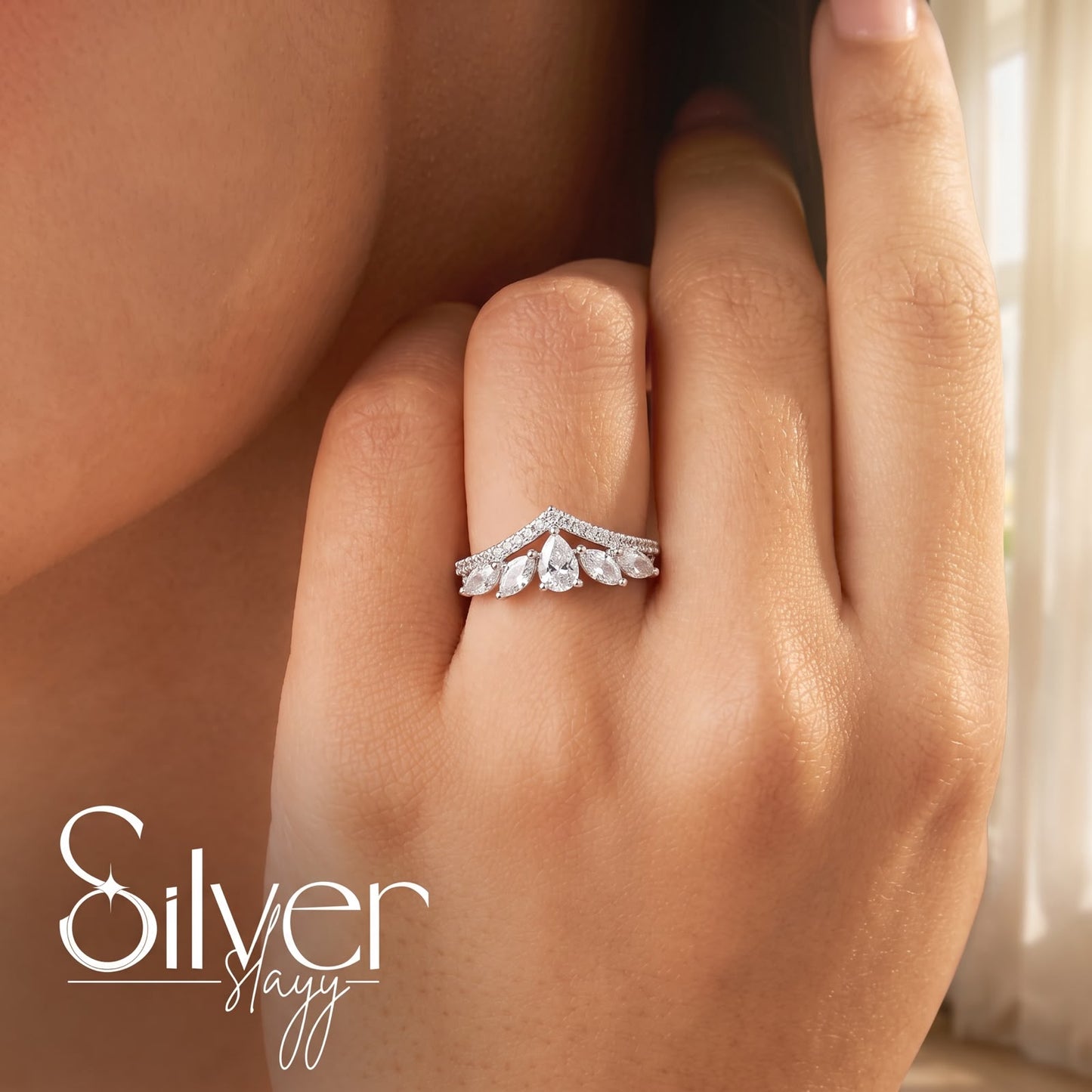 925 sterling silver ring with marquise leaf-shaped stones and a V-shaped band worn on a woman's finger.