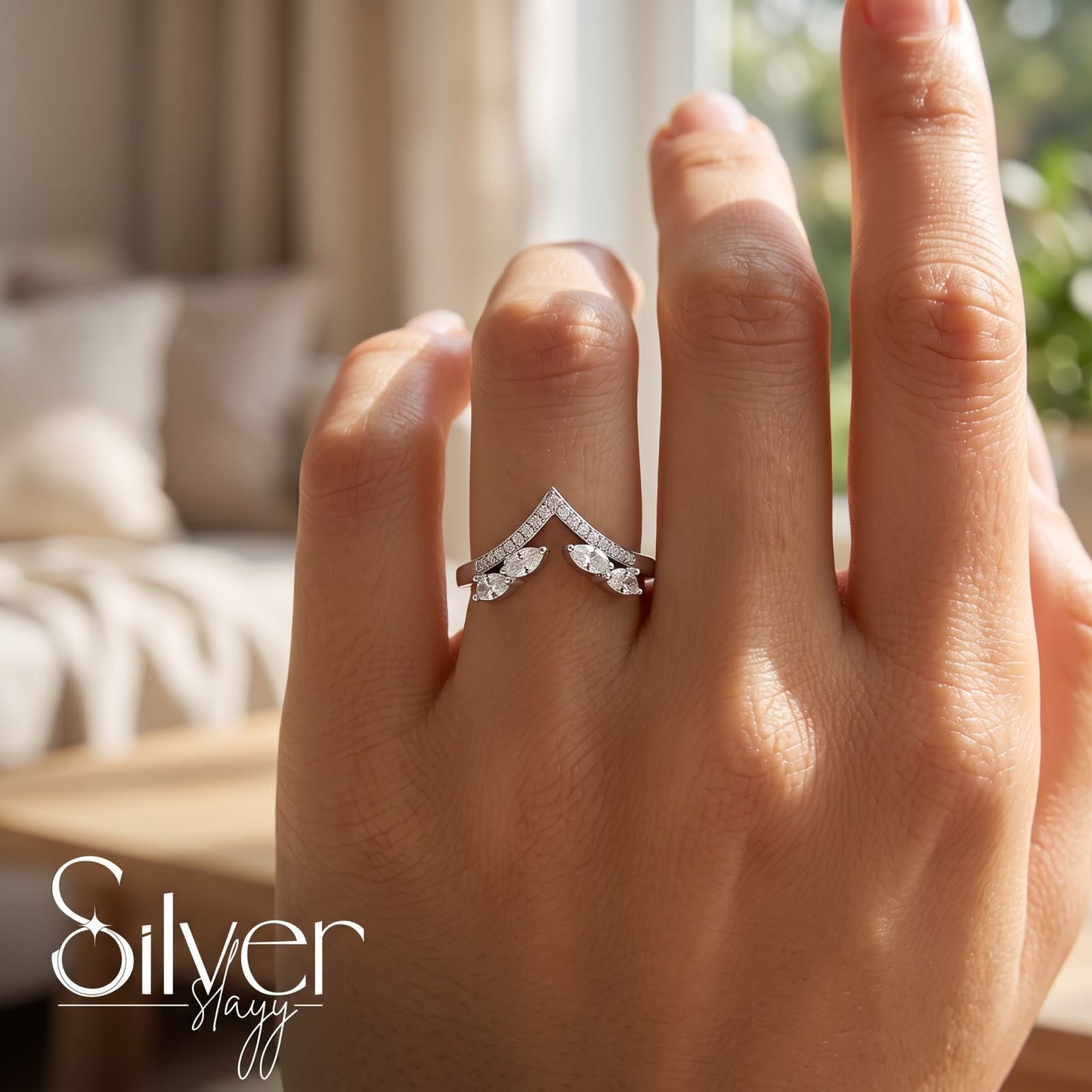 925 sterling silver chevron ring with marquise leaf-shaped stones worn on a woman's finger.
