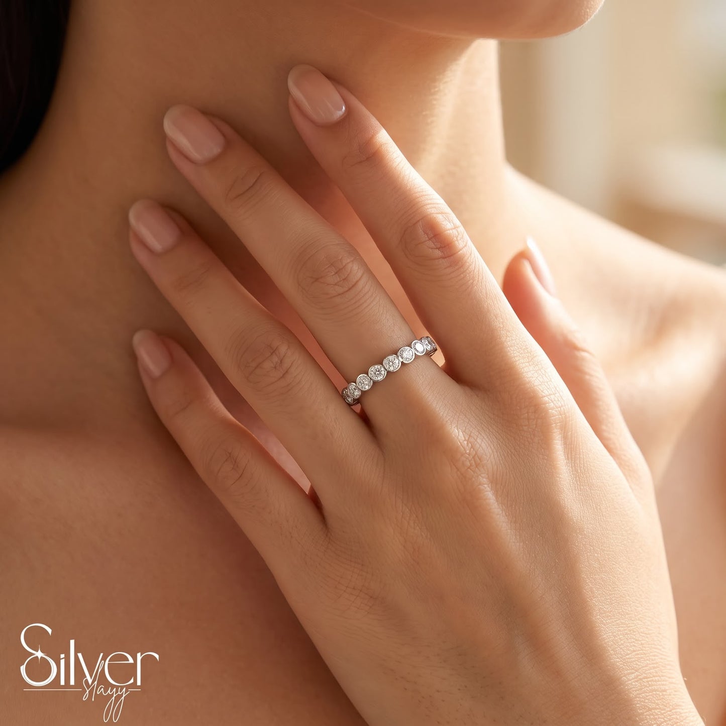 925 sterling silver expandable bezel-set stone ring worn on a woman's finger with a close-up hand-on-neck pose.