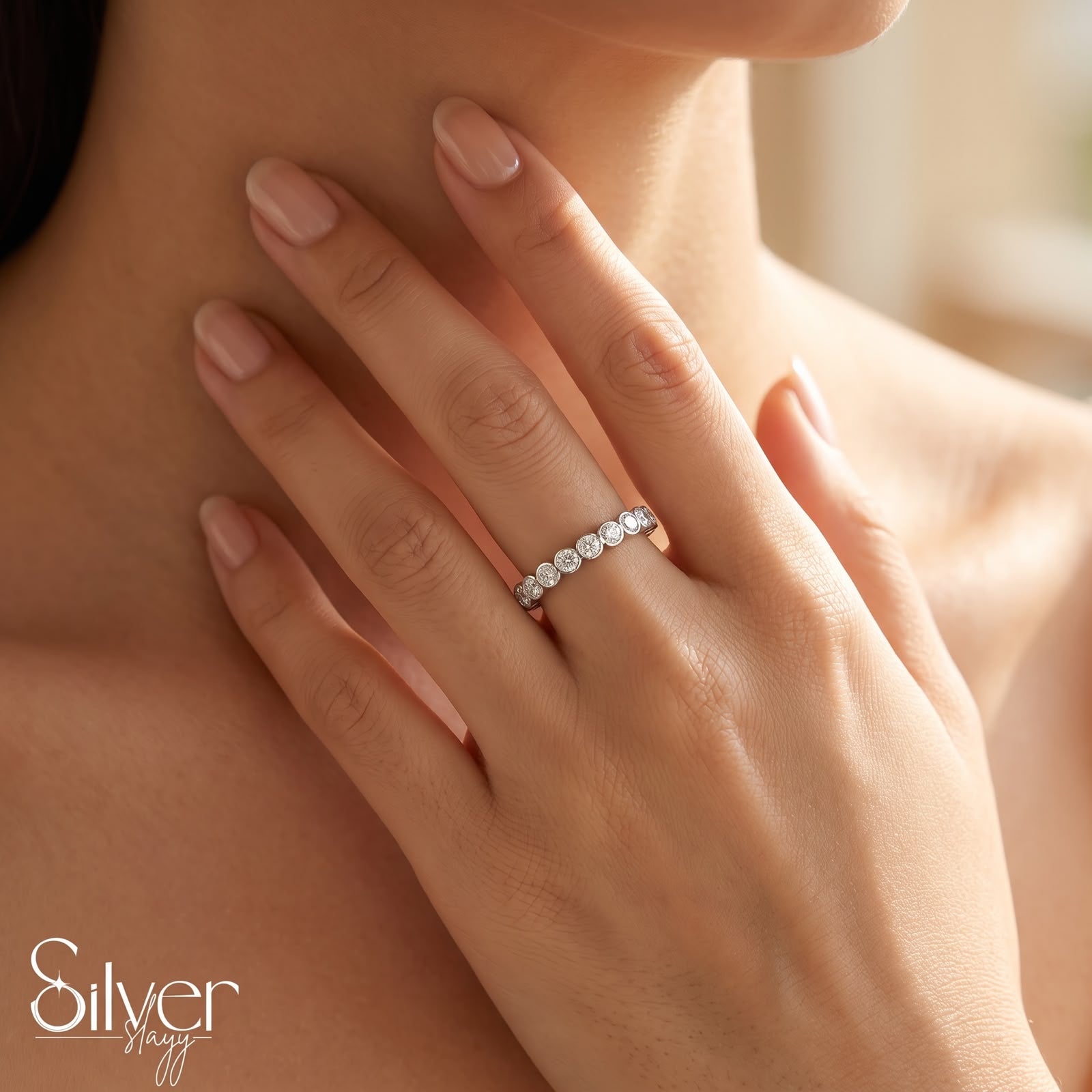 925 sterling silver expandable bezel-set stone ring worn on a woman's finger with a close-up hand-on-neck pose.