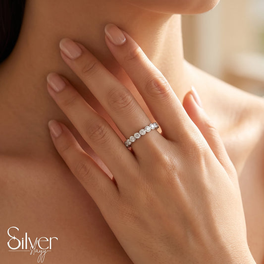 925 sterling silver expandable bezel-set stone ring worn on a woman's finger with a close-up hand-on-neck pose.