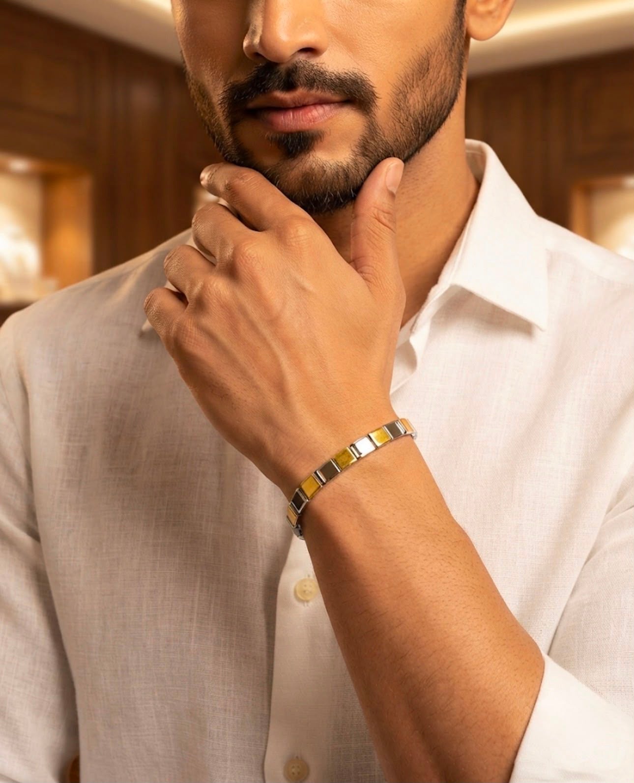 Close-up of a 925 sterling silver bracelet with alternating two-tone rectangular links worn on a man's wrist with a white shirt.