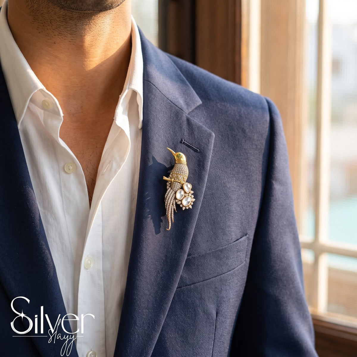 925 sterling silver bird lapel pin in gold finish worn on navy blue suit blazer for men.