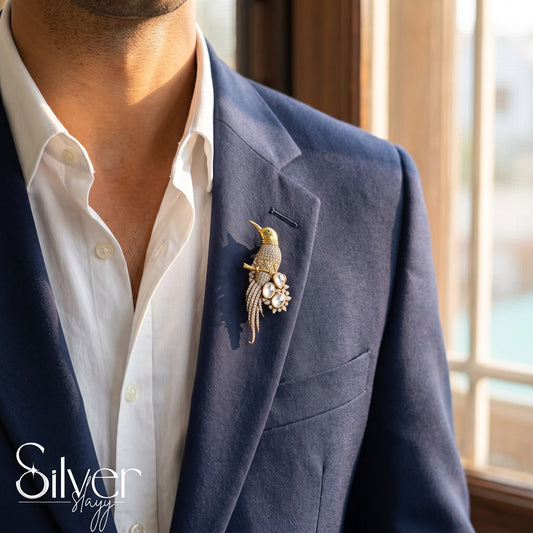 925 sterling silver bird lapel pin in gold finish worn on navy blue suit blazer for men.