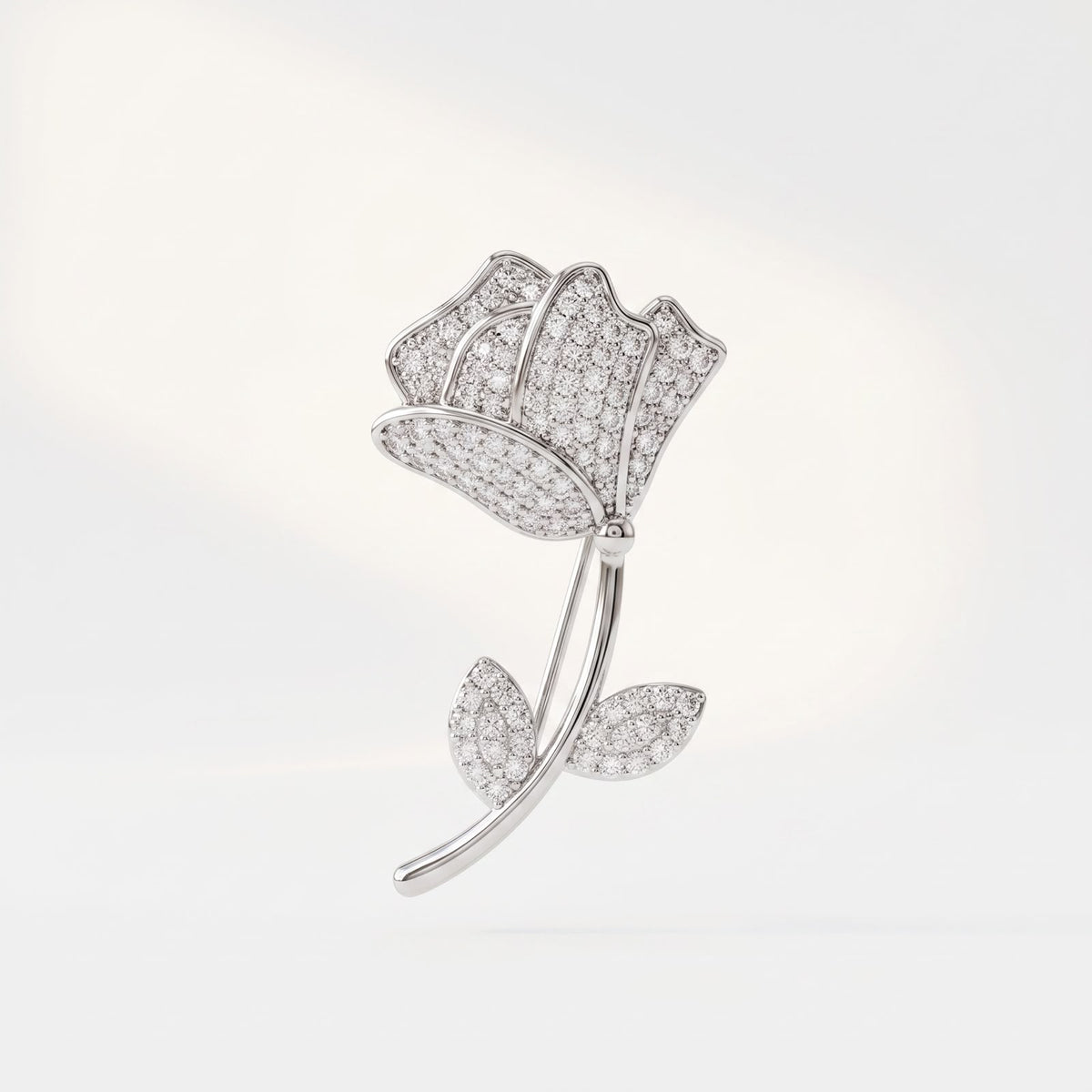 Front view of 925 sterling silver rose flower brooch with stone studded petals on white background.