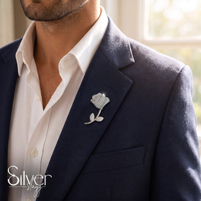 925 sterling silver blooming rose brooch with sparkling stones pinned to a navy blue blazer for men.