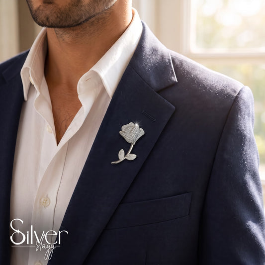 925 sterling silver blooming rose brooch with sparkling stones pinned to a navy blue blazer for men.