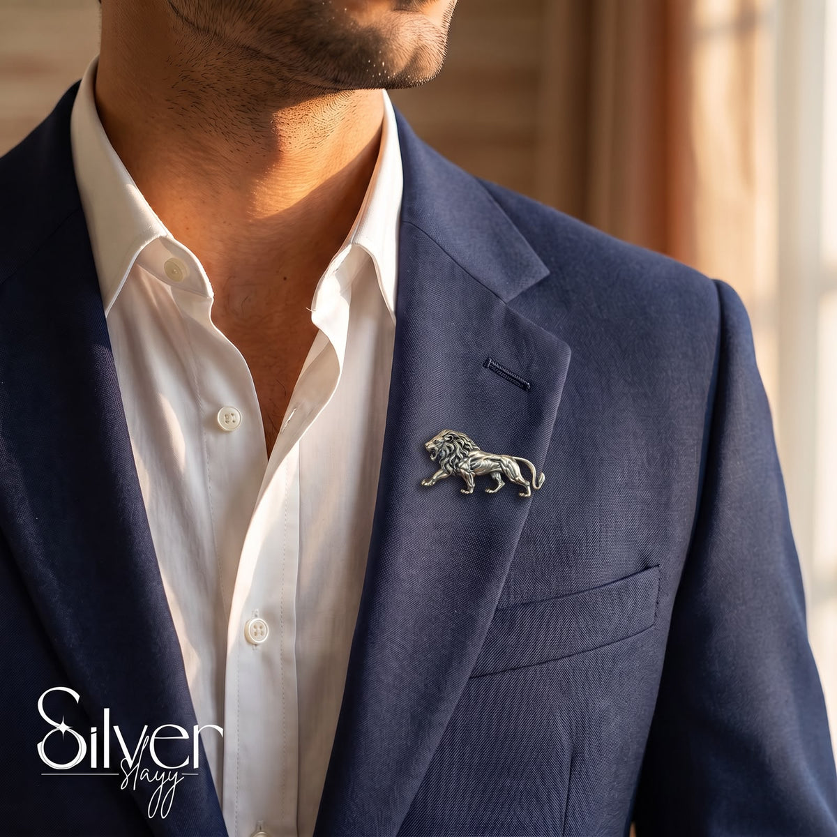 925 sterling silver antique lion brooch pinned to the lapel of a navy blue suit blazer for men.