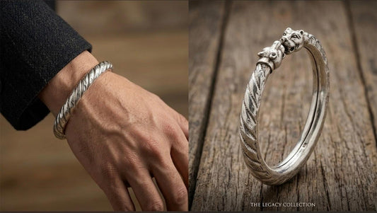 925 silver men's kada with twin lion head motifs and openable cuff design worn on a wrist.