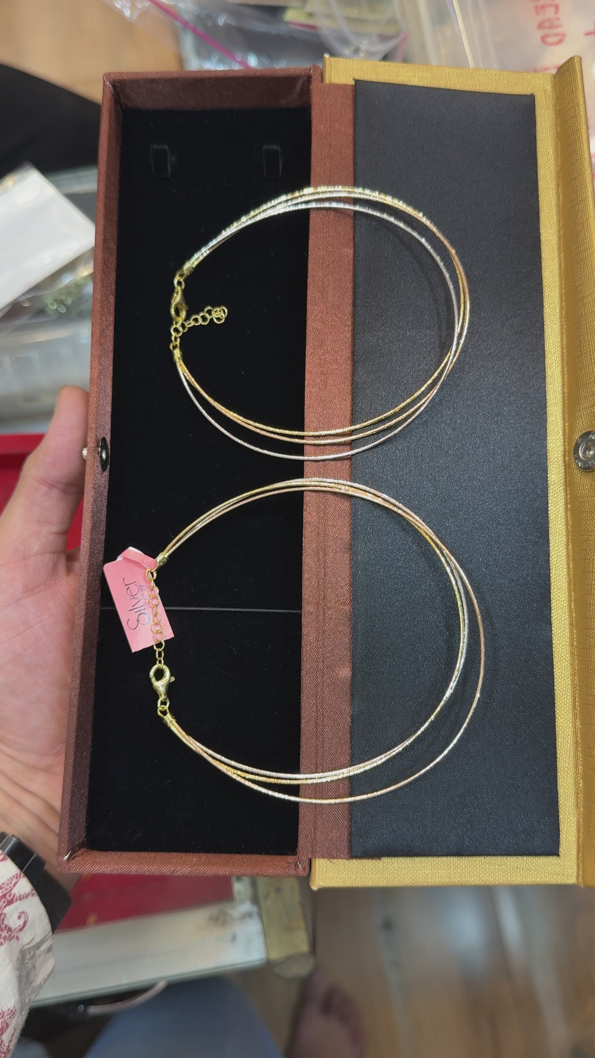 Close-up video of a 92.5 sterling silver triple-strand anklet displayed in a jewelry box, highlighting the layered chain design and adjustable clasp.